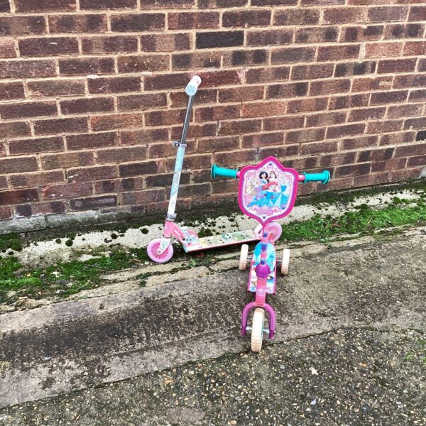 Pink and blue childrens scooters for outdoor play.
