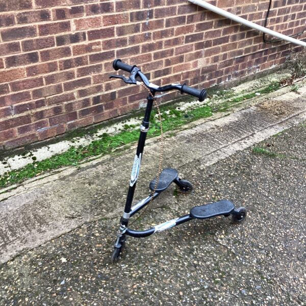 Vintage Speedser scooter with three wheels, a collectible outdoor toy.