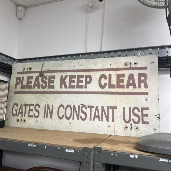Vintage keep clear gate warning sign with rust and wear.