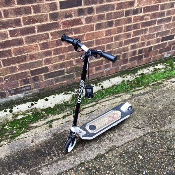 Black Zinc electric scooter, folded and ready for use.