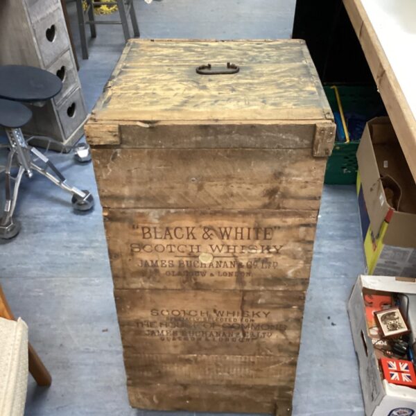 Vintage Black and White Scotch Whisky crate with weathered wood and bold branding.