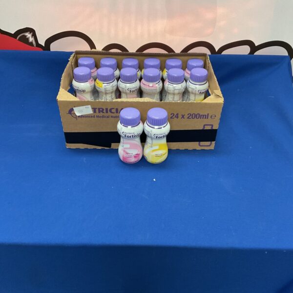 Box of unopened Nutricia Fortisip banana and strawberry milkshakes.