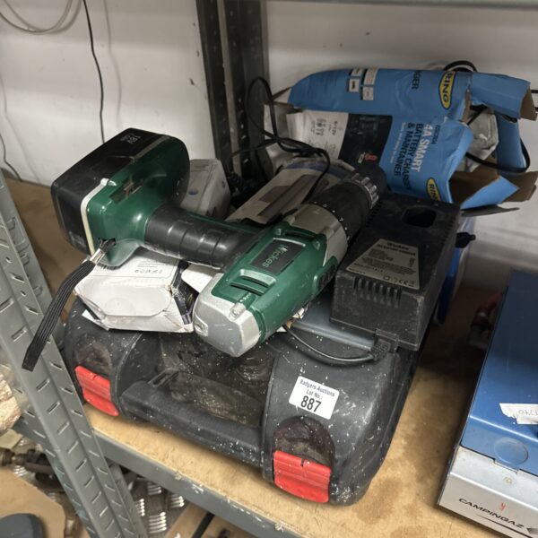 Green electric hedge trimmer from a garden tool lot.