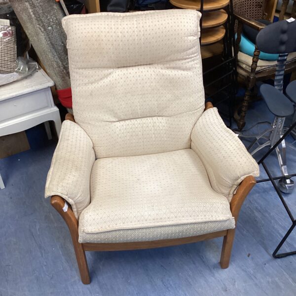 Vintage Ercol armchair with beech wood frame and patterned upholstery.