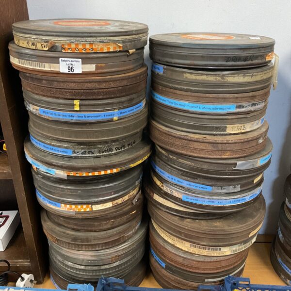 Lot of vintage 35mm movie reels and canisters, collectible film.