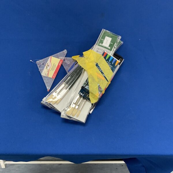 Assorted arts and crafts lot with paint brushes and patchwork rulers.