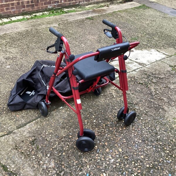 Red Uniscan walking aid trolley with basket and seat.