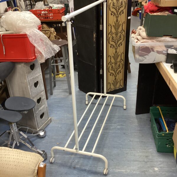 White wheeled clothes rail for garment storage and display.