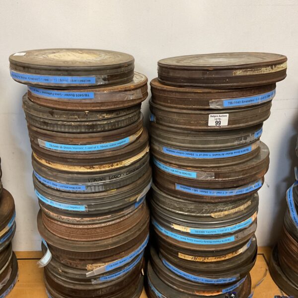 Vintage 35mm movie reels and metal canisters in a collection.