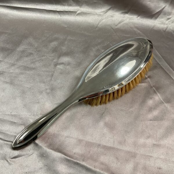 Antique silver clothes brush with natural bristles, Victorian era.
