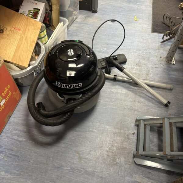 Vintage Nuvac cylinder vacuum cleaner for home cleaning.