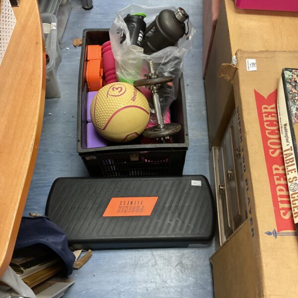 Mixed lot of fitness equipment including dumbbells and bottles.