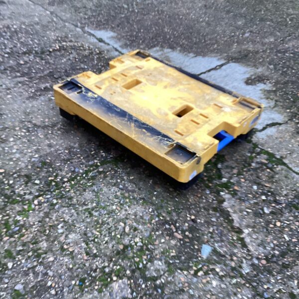 Durable heavy-duty pallet skate for moving industrial loads.