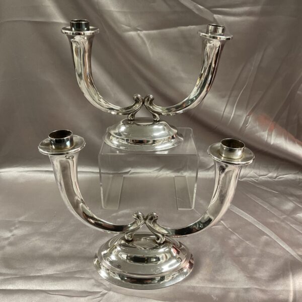 Elegant argentor silver two-branch candelabra on a reflective surface.