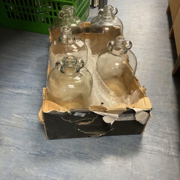 Lot of five vintage demi john bottles for storage.