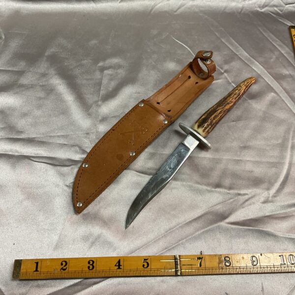 Vintage Sheffield stag horn knife with leather sheath.