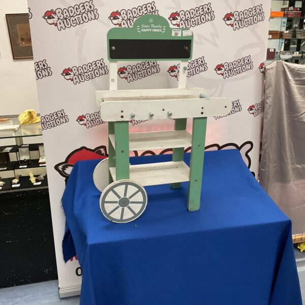 Vintage child's florist stool with green and white paint.