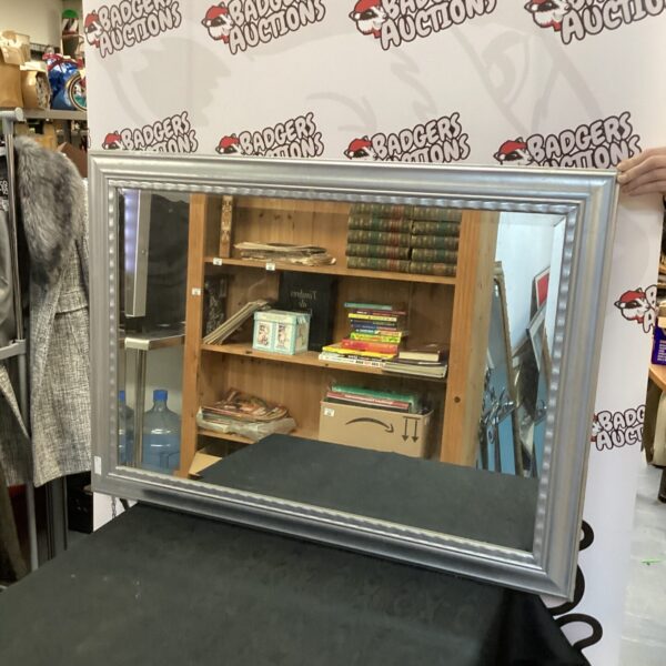 Large framed bevel edge mirror for home decor.