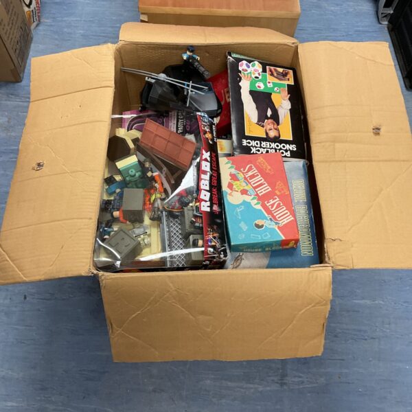 Mixed toy lot with Roblox set and board games inside a box.