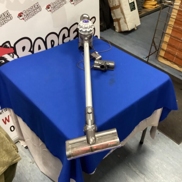 Blue Dyson cordless vacuum cleaner presented for auction.