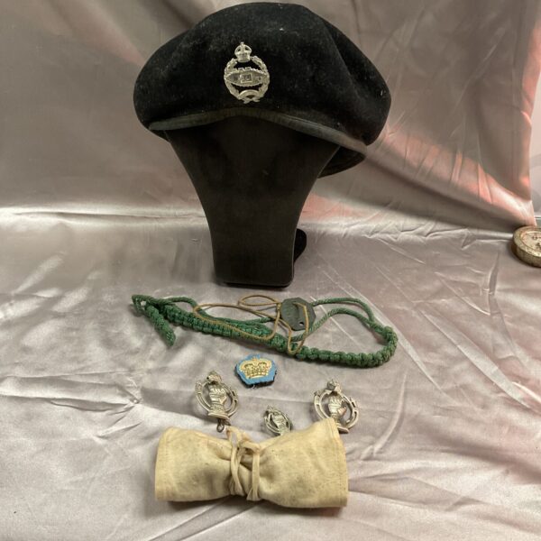 Vintage British Army tank regiment beret with badge and lanyard.