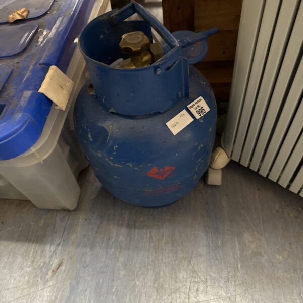 Empty blue Calor Gas bottle for camping and outdoor use.