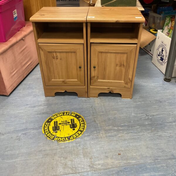 Pair of pine effect bedside cabinets with drawer and shelf.