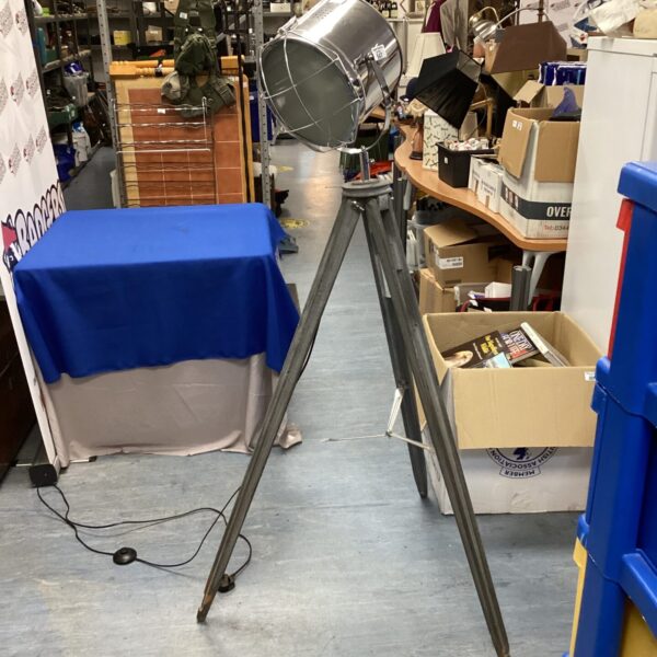 Vintage tripod spotlight lamp with adjustable shade.