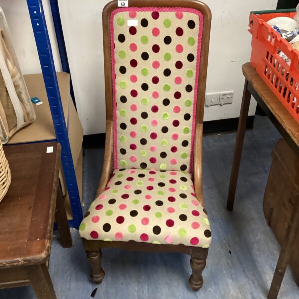 Vintage polka dot nursing chair with wooden frame.