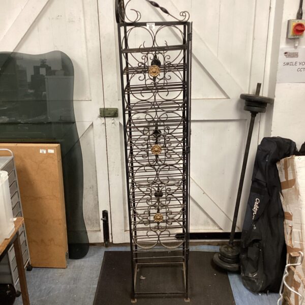 Vintage wrought iron wine rack for displaying wine bottles.