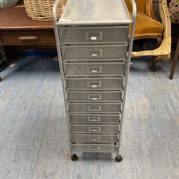 Vintage metal wheeled filing cabinet for office storage.