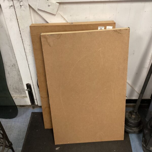 Two vintage wood pasting tables for workshop or craft use.