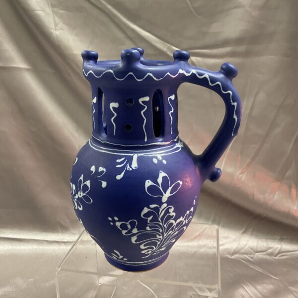 Vintage blue ceramic puzzle jug with multiple openings.