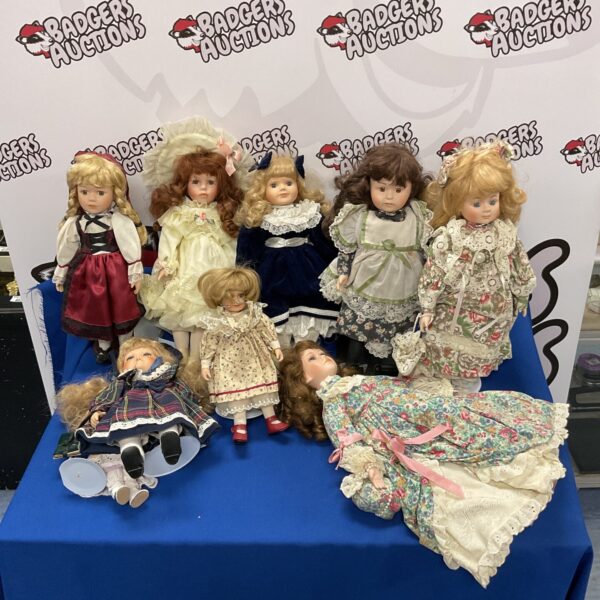 A lot of vintage collectable dolls with varied clothing.