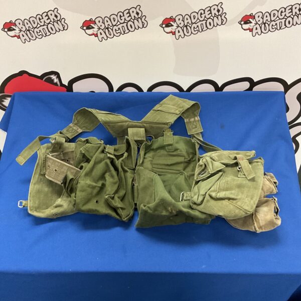 Vintage military webbing vest with multiple pouches.