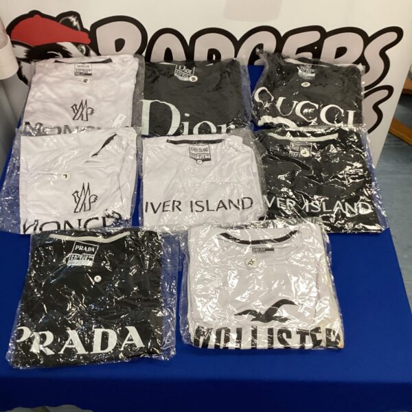 Overview of a lot of designer-style T-shirts in various sizes.