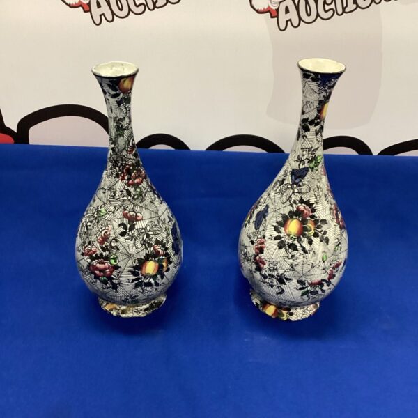 Antique Japanese porcelain vases with vibrant floral design.