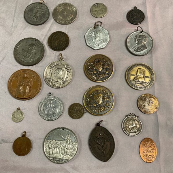 Vintage commemorative medals and coins in a collection.