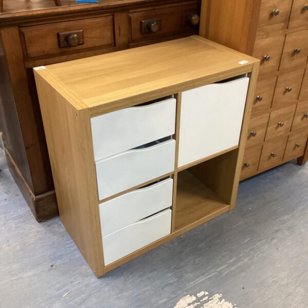 Wooden three-drawer bedroom unit for storage.