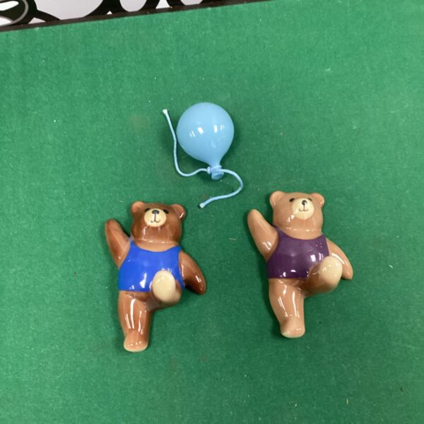 Vintage porcelain bears holding a balloon, collectible figurines.
