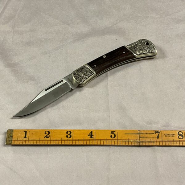 Vintage Bridgedale pocket knife with decorative handle and stainless steel blade.