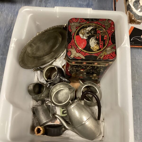 Vintage silverplate tea set with teapot, milk jug, and sugar bowl.