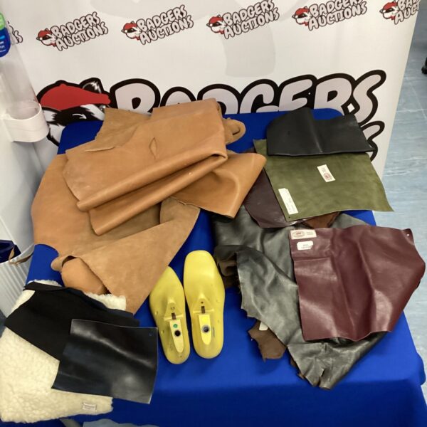 Mixed lot of leather and suede offcuts with shoe stretchers for crafting.