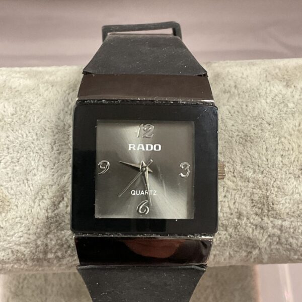 Rado quartz wristwatch with a black dial and stainless steel band.