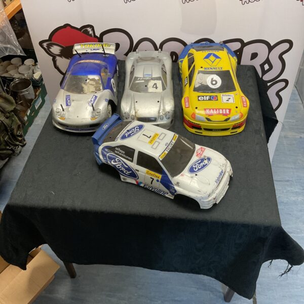 Lot of four RC race cars with colourful shells.