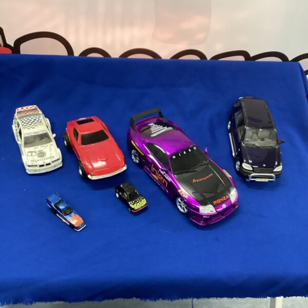 Diecast model cars lot featuring a Toyota Supra and Tonka truck.