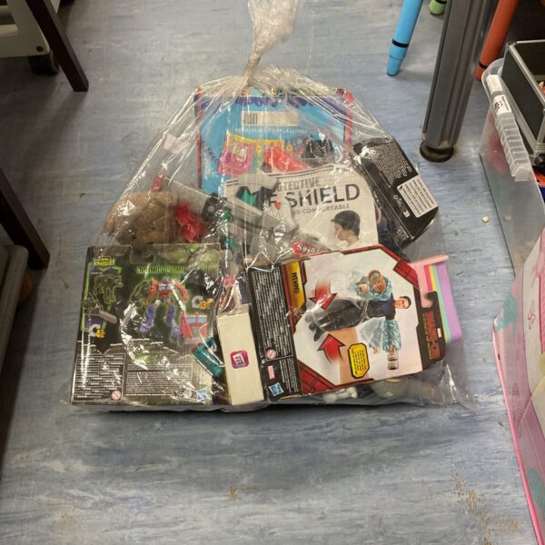 Sealed plastic bag containing a mixed toy lot with Transformers.