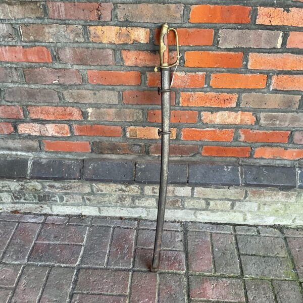 Victorian British Indian Army sword displayed against a brick wall.