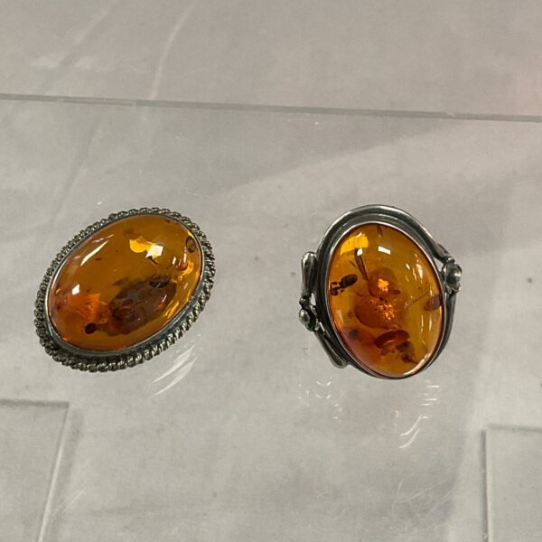 Close-up of vintage silver ring with amber stone.