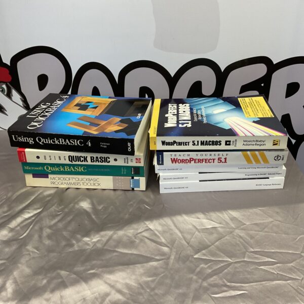 Vintage lot of Microsoft QuickBASIC and WordPerfect manuals for collectors.